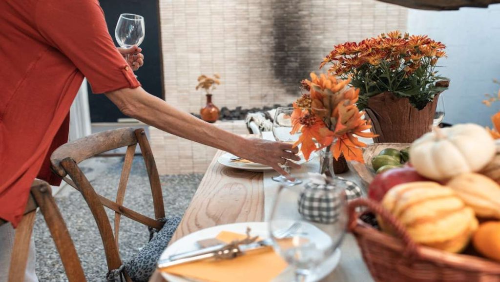 Woman setting up Thanksgiving table