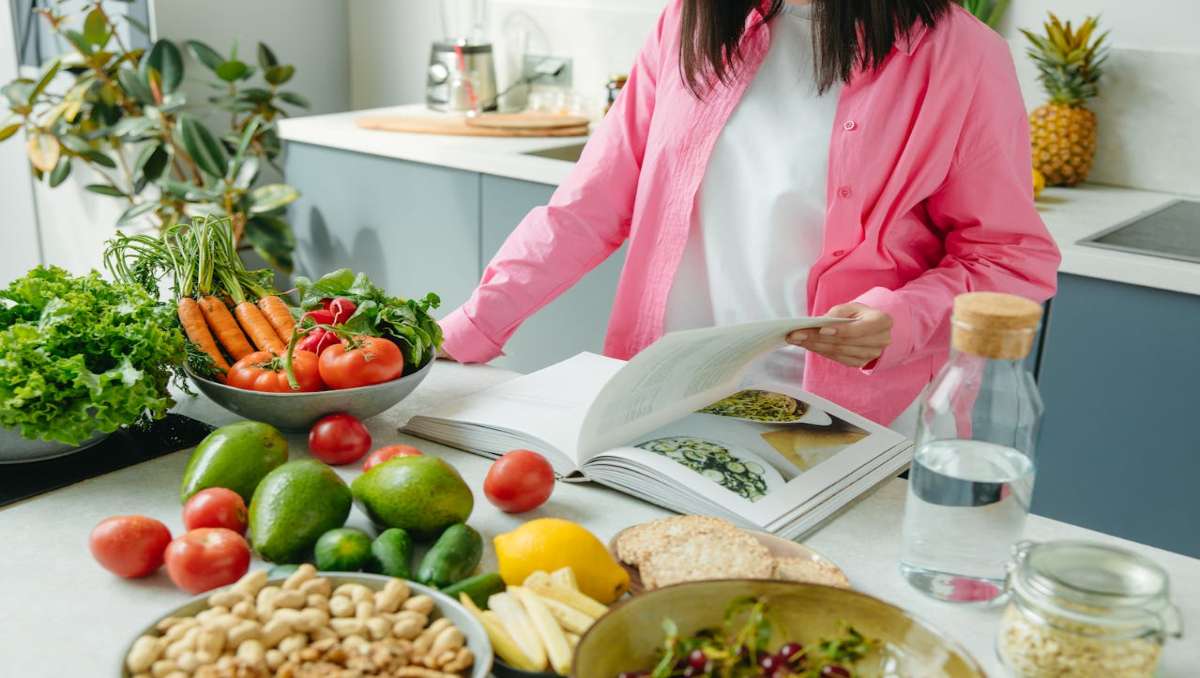 Woman reading amish cookbook in the kitchen