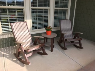 Two Poly Vinyl Comfort Rockers and a Poly Vinyl Deluxe End Table in color weatherwood with chestnut brown legs and trim