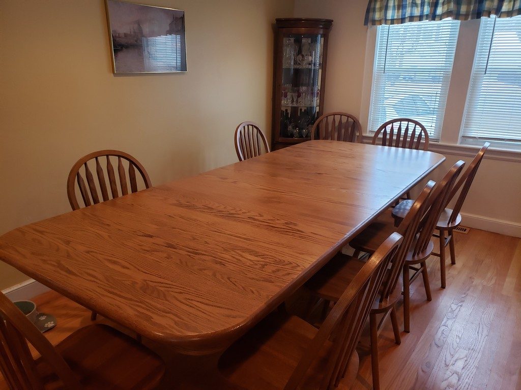 This Double Pedestal Dining Table made of walnut has all four leaves in for a length of ten feet.