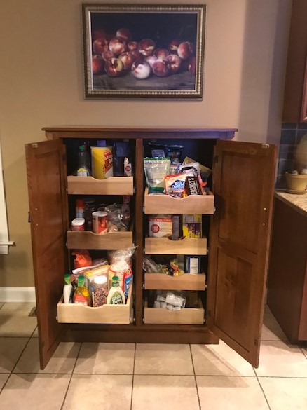 Mary's pantry cabinet has eight shelves that slide out like drawers.