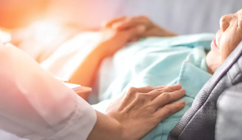 do amish go to doctors Old sick woman lying down while being treated by a hand