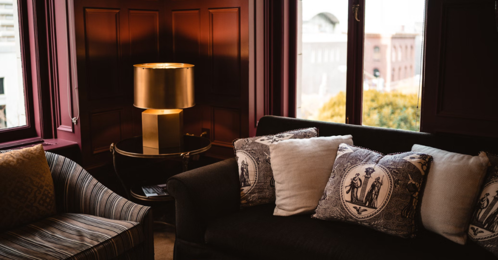 what color furniture goes with dark wood floors Accent pieces like light and pillows in a dark room with dark wood floor