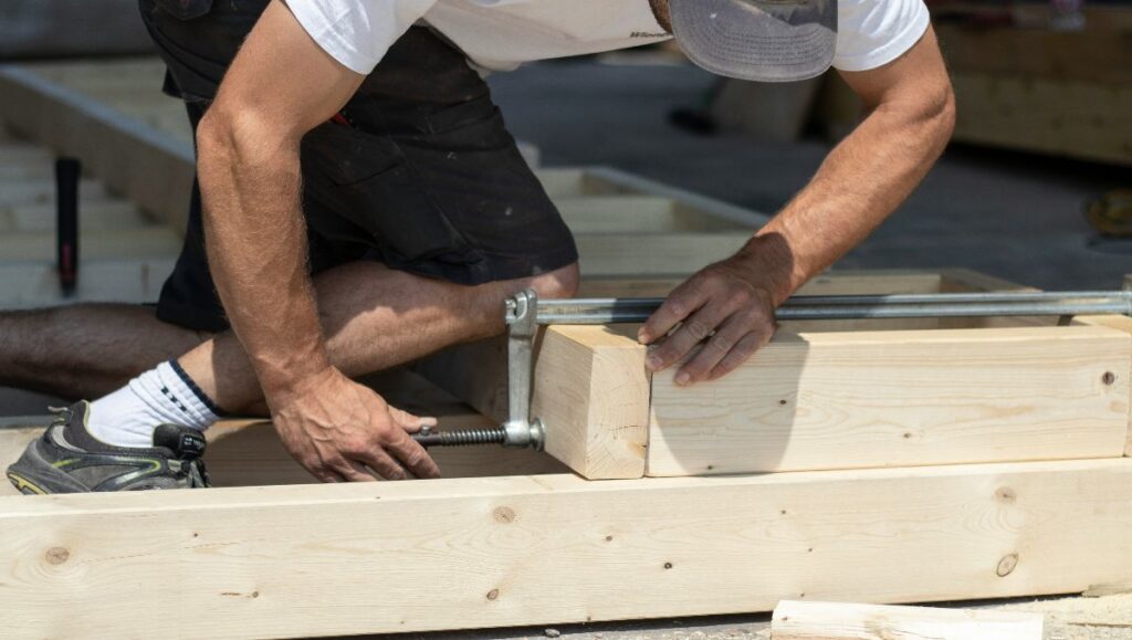A man working on the wooden frames.