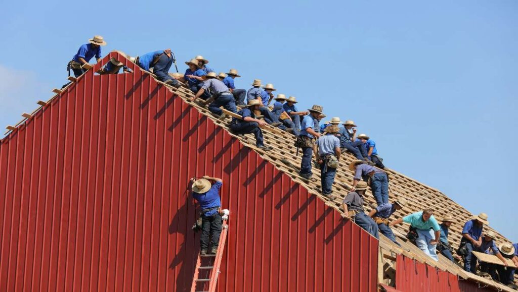 Amish people doing roof construction.