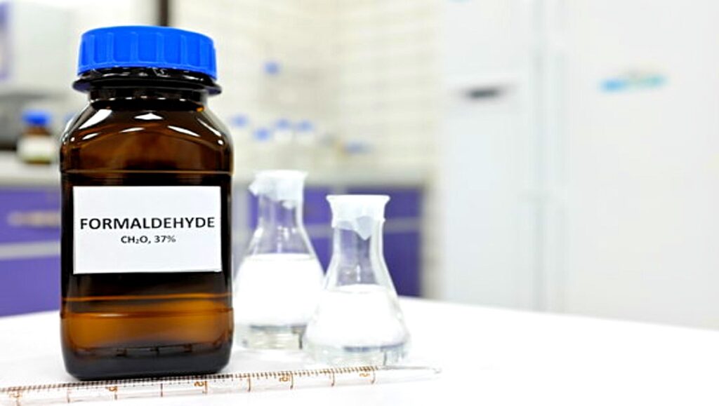 A bottle of formaldehyde in a lab table.