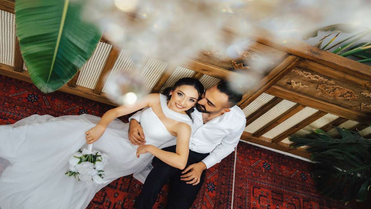 Romantic wedding couple embracing on balcony