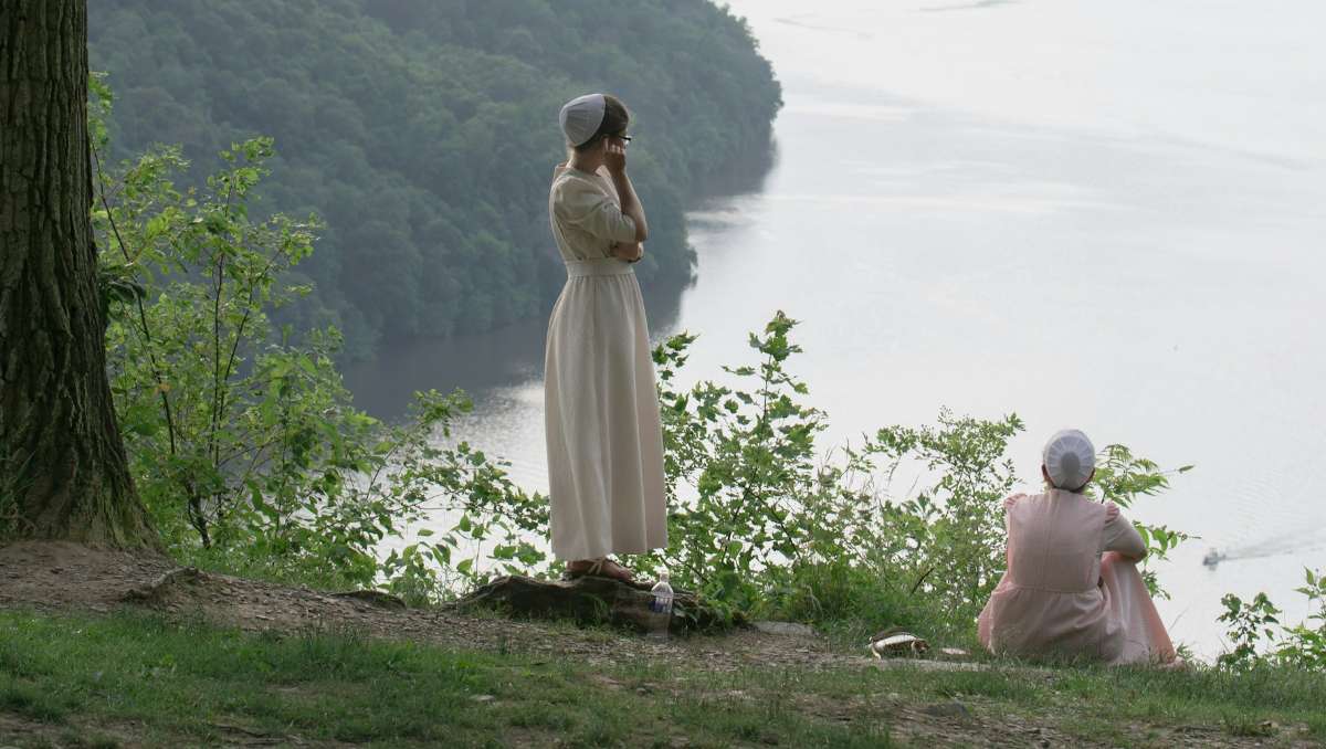 Two amish girls overlooking ocean view