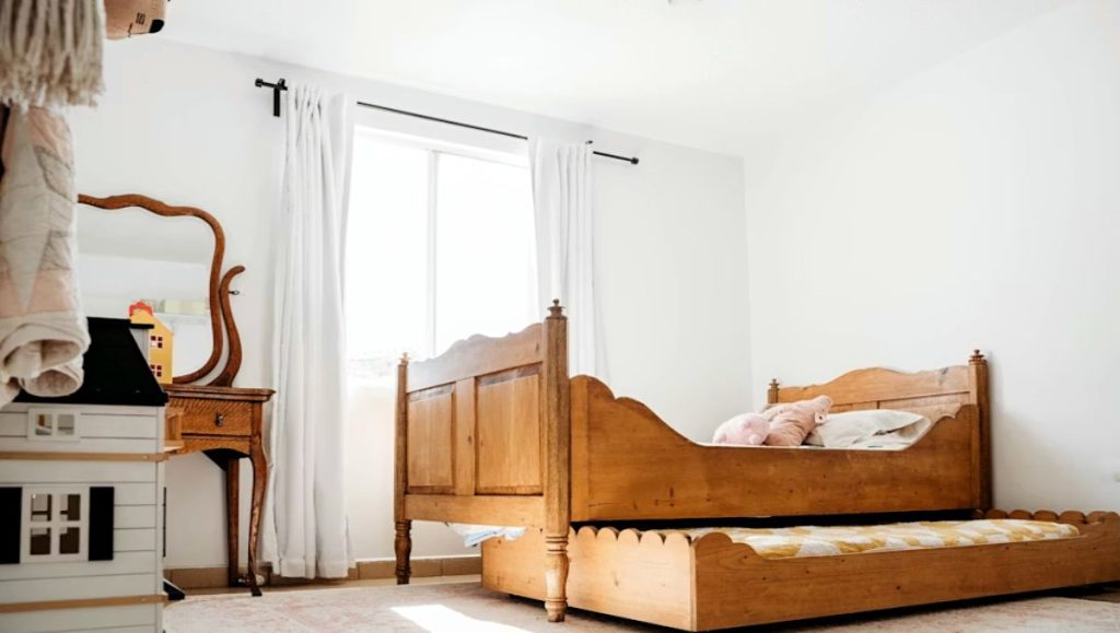 A mission-style bedroom with wooden bed and storage