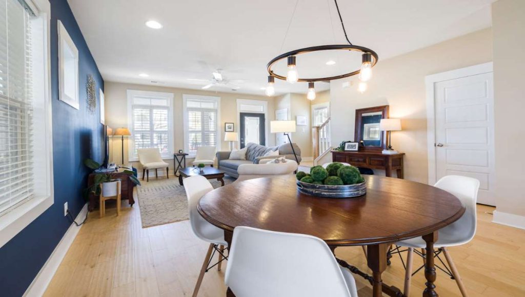 Condo with dining table with lighting on top